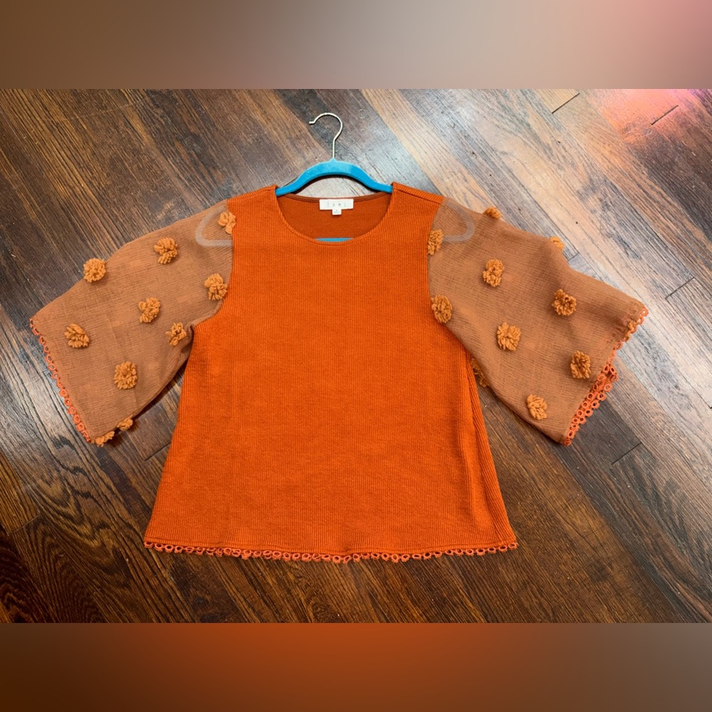 Women’s orange 3/4 sleeve fall shirt with Pom poms on  sleeves